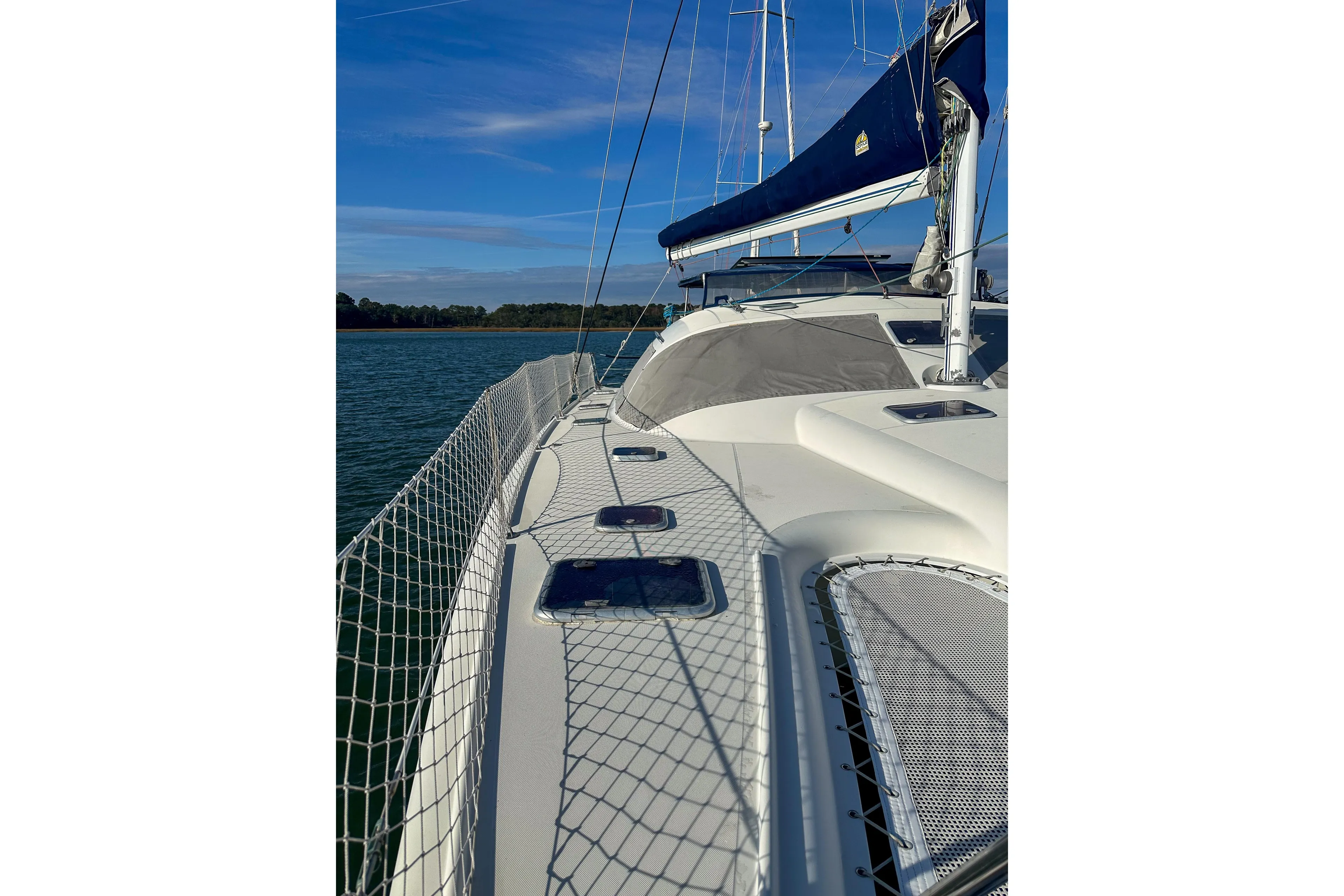 Sailing yacht Privilege 435, 2001 model, on calm waters under a clear blue sky.