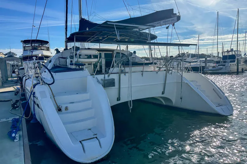 Mystic Yacht Photos Pics Catamaran Privilege 435, 2001 model, docked at marina under clear blue sky.