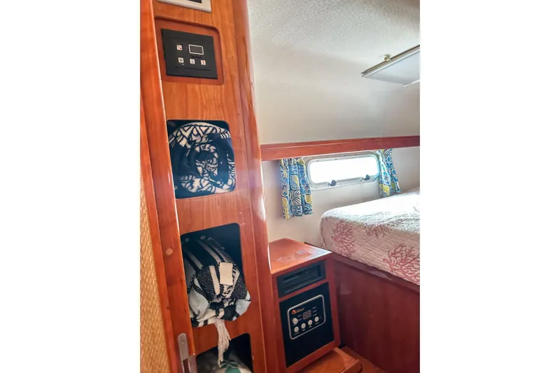 Mystic Yacht Photos Pics Interior of 2001 Privilege 435 yacht with cozy cabin and storage shelves.