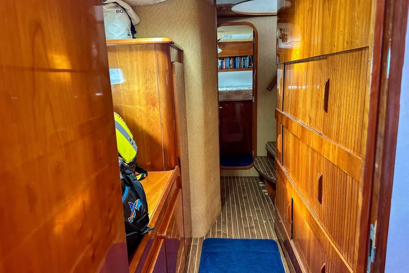 Mystic Yacht Photos Pics Luxurious wooden interior of 2001 Privilege 435 yacht hallway with storage and seating.