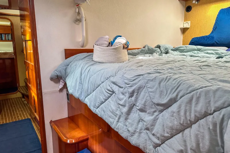 Mystic Yacht Photos Pics Cozy cabin interior of 2001 Privilege 435 yacht with bed and wooden accents.