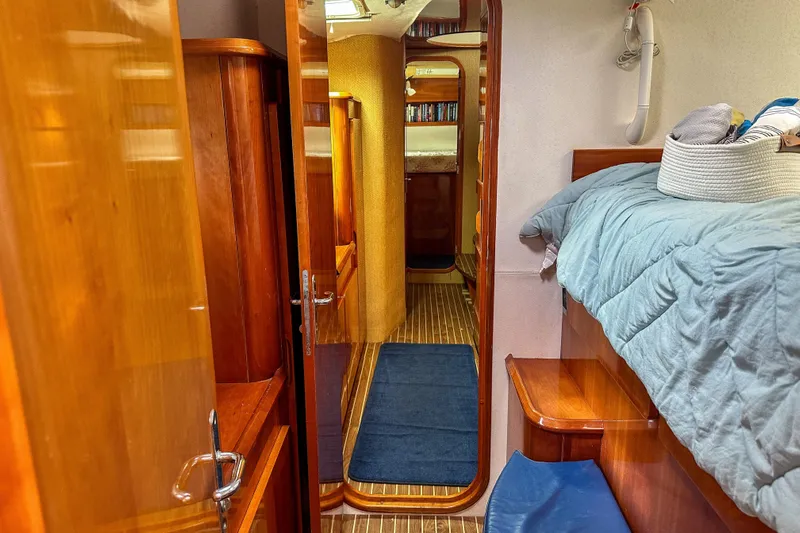 Mystic Yacht Photos Pics Interior of 2001 Privilege 435 yacht with wooden furnishings and cozy bedding.
