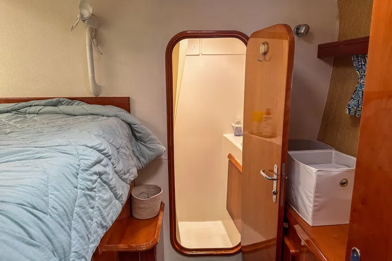 Mystic Yacht Photos Pics Cozy cabin interior of 2001 Privilege 435 yacht with bed and storage.