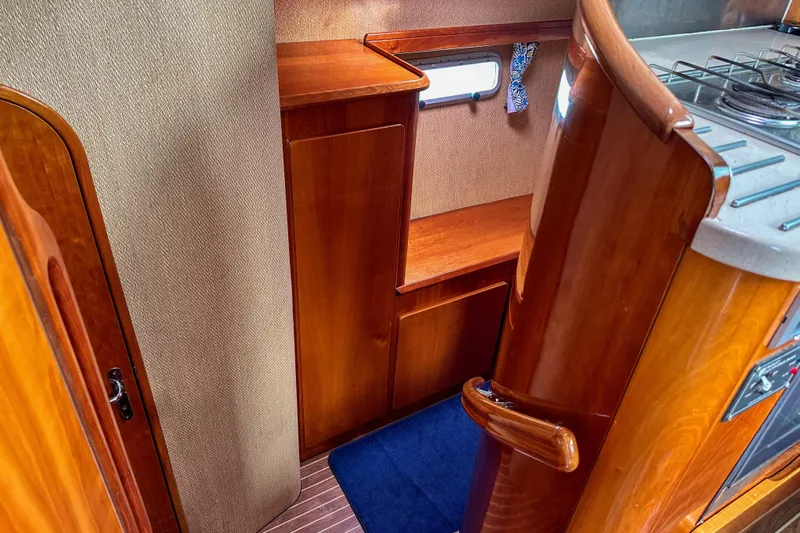 Mystic Yacht Photos Pics Interior of 2001 Privilege 435 yacht with wooden cabinetry and compact kitchen area.