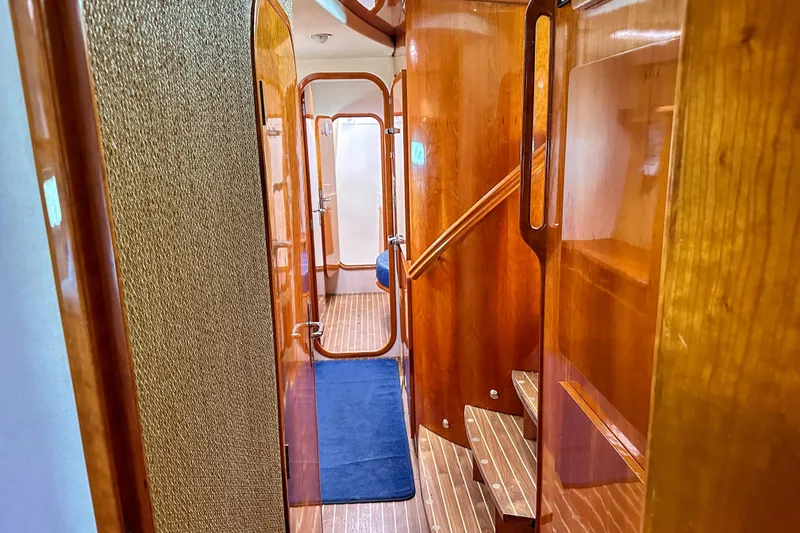 Mystic Yacht Photos Pics Luxurious wooden interior of 2001 Privilege 435 yacht with stairs and hallway.