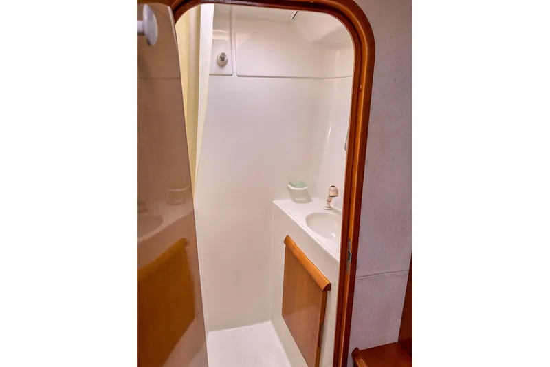Mystic Yacht Photos Pics Compact bathroom interior of 2001 Privilege 435 yacht with sink and wooden accents.