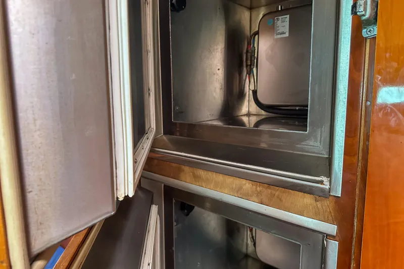 Mystic Yacht Photos Pics Stainless steel storage compartments inside a 2001 Privilege 435 yacht.