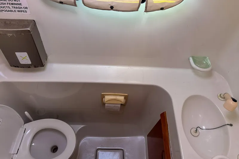 Mystic Yacht Photos Pics Bathroom interior of 2001 Privilege 435 yacht, featuring toilet and sink.