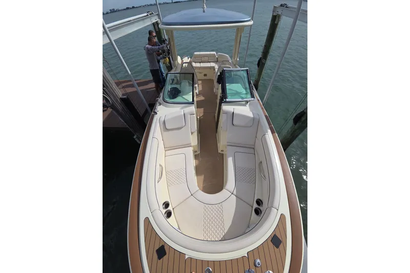  Yacht Photos Pics 2023 Chris-Craft Launch 28 GT boat with elegant seating and teak accents docked by the water.