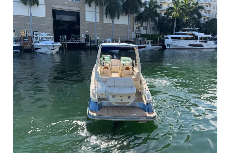 Yacht Photos Pics 2023 Chris-Craft Launch 28 GT boat docked in a marina with palm trees.