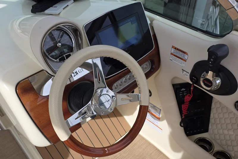  Yacht Photos Pics 2023 Chris-Craft Launch 28 GT dashboard with steering wheel and control panel.