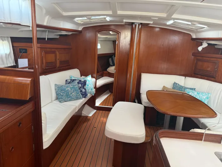 Traveler Yacht Photos Pics Interior of 2002 Beneteau 473 yacht with wooden finish and white seating.