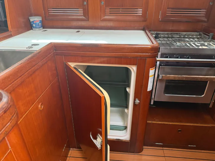 Traveler Yacht Photos Pics Galley kitchen in 2002 Beneteau 473 yacht with open fridge and stove.
