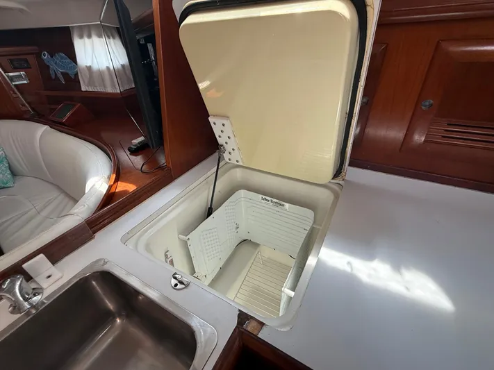 Traveler Yacht Photos Pics Interior of 2002 Beneteau 473 yacht showing open storage compartment and sink.