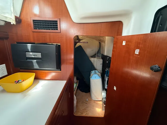 Traveler Yacht Photos Pics Interior of a 2002 Beneteau 473 sailboat with storage compartment and Dometic appliance.