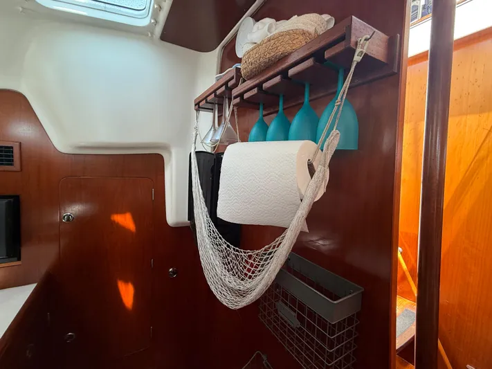 Traveler Yacht Photos Pics Interior of 2002 Beneteau 473 yacht with organized storage and wooden finish.