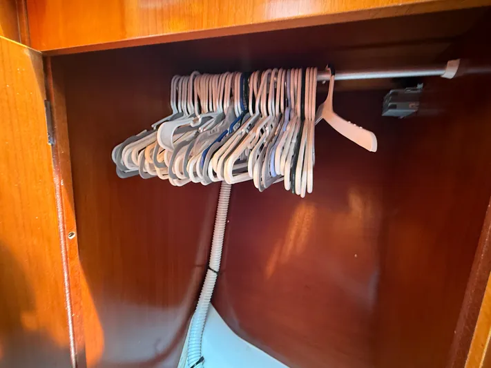 Traveler Yacht Photos Pics Wooden closet with hangers inside a 2002 Beneteau 473 yacht.