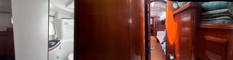 Traveler Yacht Photos Pics Interior of 2002 Beneteau 473 yacht, featuring wood paneling and cozy cabin spaces.