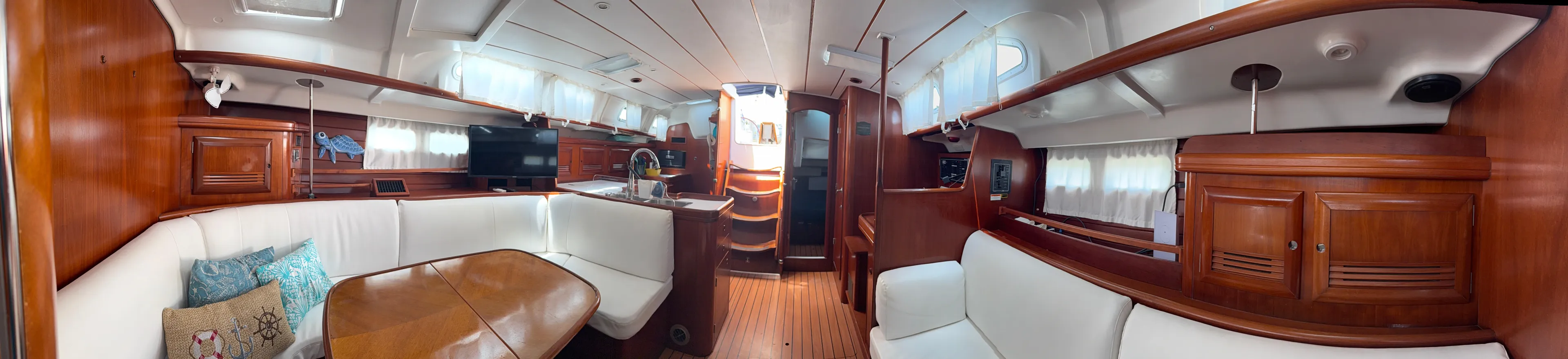 Traveler Yacht Photos Pics Interior of 2002 Beneteau 473 yacht with elegant wood finish and spacious seating area.