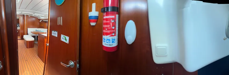 Traveler Yacht Photos Pics Interior of a 2002 Beneteau 473 sailboat, featuring wooden finishes and safety equipment.