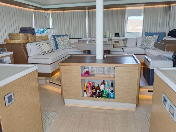  Yacht Photos Pics Luxurious interior of a 2018 Lagoon 50 yacht with modern furnishings and a stocked bar.