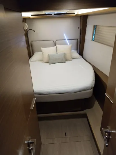  Yacht Photos Pics Cozy bedroom interior of 2018 Lagoon 50 yacht with modern design and comfortable bedding.