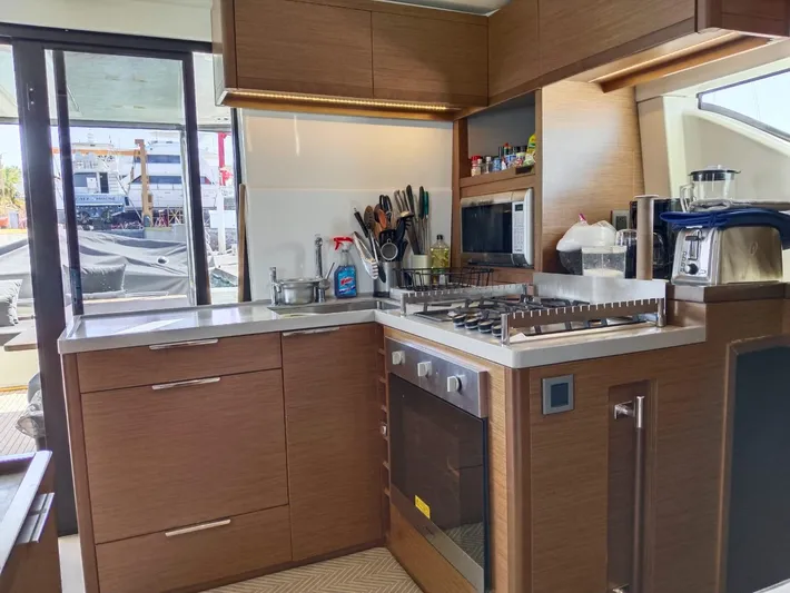  Yacht Photos Pics Modern kitchen interior on a 2018 Lagoon 50 yacht, featuring sleek cabinetry and appliances.