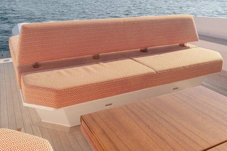  Yacht Photos Pics 2024 Delta Powerboats 60 Open yacht with patterned seating and wooden table on deck.