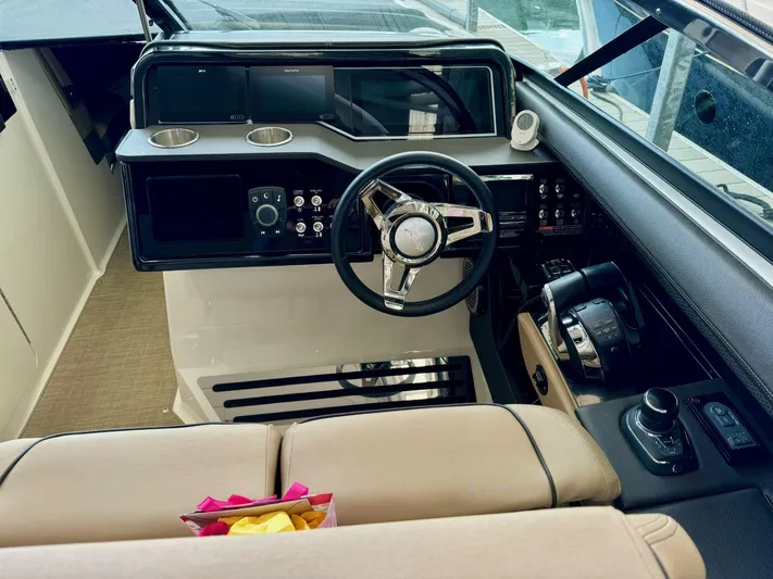  Yacht Photos Pics 2018 Sea Ray SLX 310 boat cockpit with steering wheel and control panel.