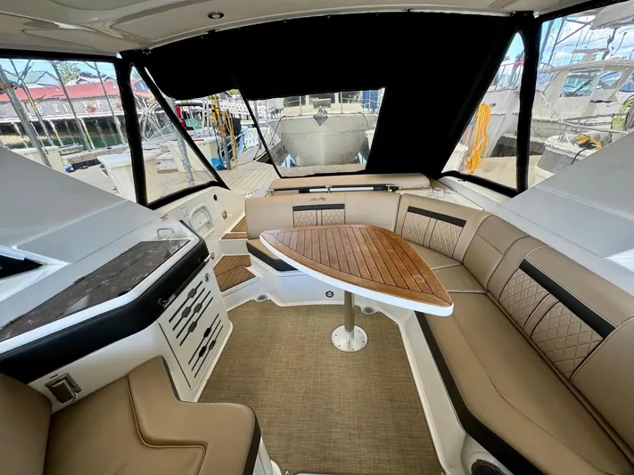  Yacht Photos Pics 2018 Sea Ray SLX 310 interior with tan seating and wooden table.