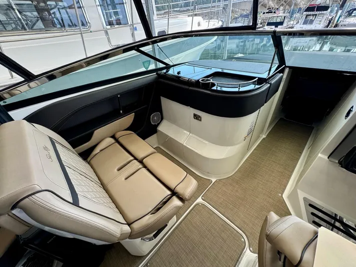  Yacht Photos Pics 2018 Sea Ray SLX 310 boat interior with beige seating and helm station.