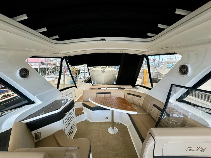  Yacht Photos Pics Interior of 2018 Sea Ray SLX 310 boat with seating and table.