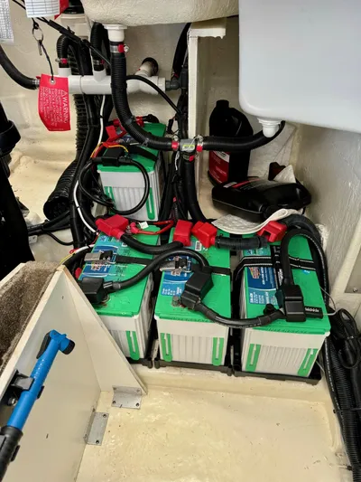  Yacht Photos Pics Battery compartment of a 2018 Sea Ray SLX 310 boat with three green batteries.
