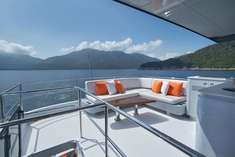  Yacht Photos Pics 2024 CL Yachts CLB65 yacht deck with seating, ocean view, and mountains in the background.