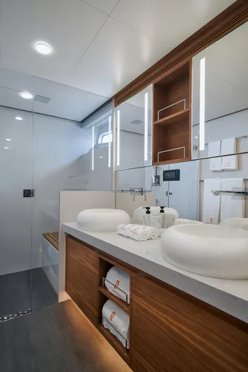  Yacht Photos Pics Luxurious bathroom in 2024 CL Yachts CLB65, featuring modern fixtures and elegant wood accents.