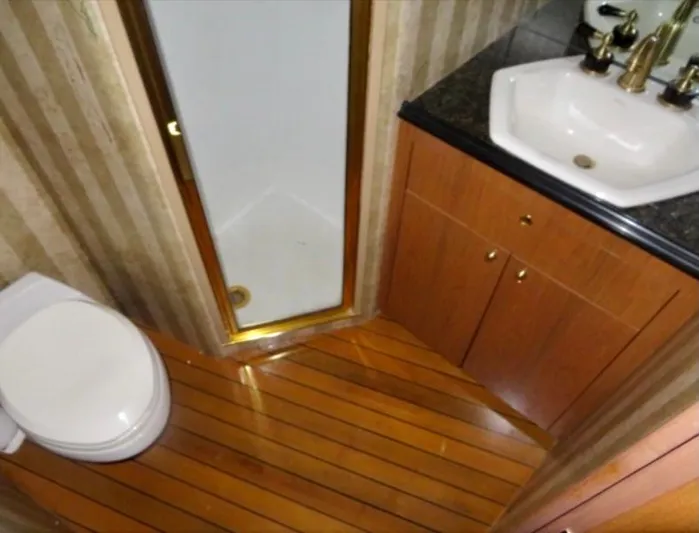  Yacht Photos Pics Luxury yacht bathroom with wood flooring, shower, and sink. Buddy Davis 78, 2000 model.