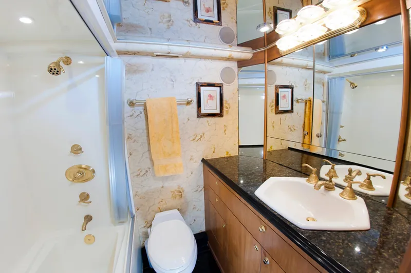  Yacht Photos Pics Luxurious bathroom in 2000 Buddy Davis 78 yacht with marble walls and gold fixtures.