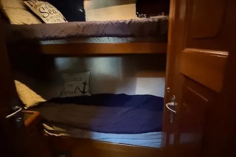 Fellowship Yacht Photos Pics 2001 Grand Alaskan Pilothouse interior with cozy bunk beds and nautical-themed decor.