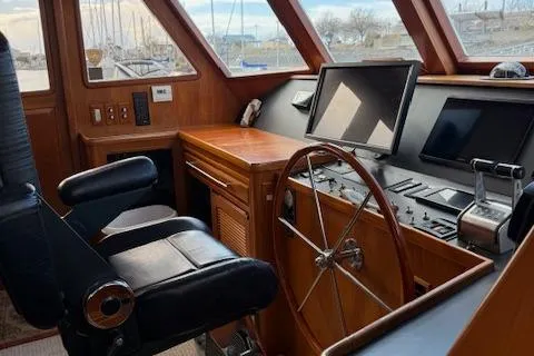Fellowship Yacht Photos Pics Pilothouse interior of 2001 Grand Alaskan, featuring navigation controls and captain's chair.