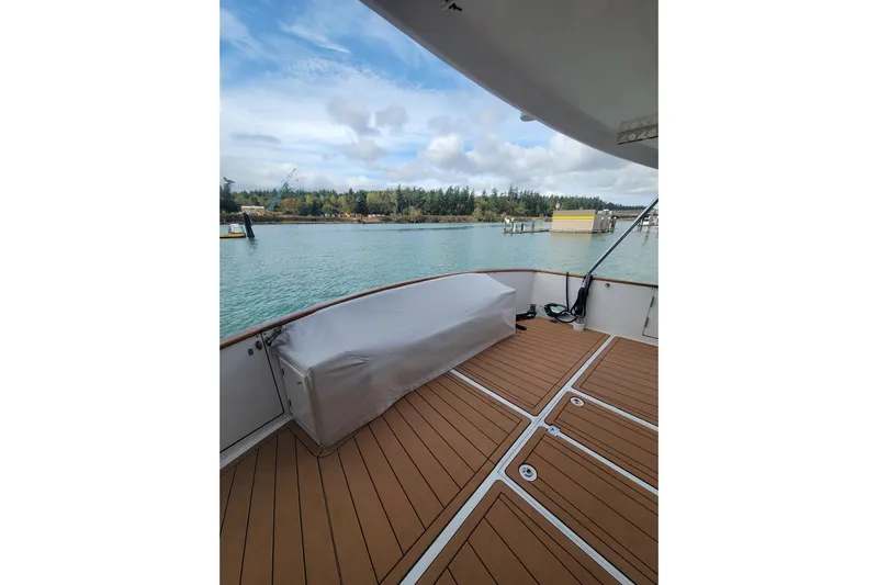 Fellowship Yacht Photos Pics 2001 Grand Alaskan Pilothouse boat deck with scenic waterfront view.