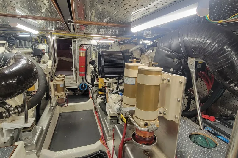 Fellowship Yacht Photos Pics Engine room of 2001 Grand Alaskan Pilothouse yacht, featuring mechanical components and equipment.