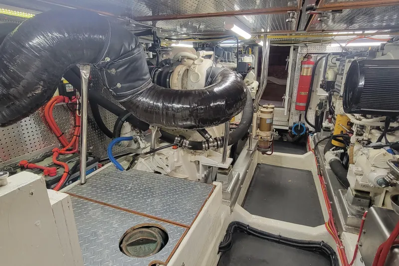 Fellowship Yacht Photos Pics Engine room of 2001 Grand Alaskan Pilothouse yacht, featuring complex machinery and piping.