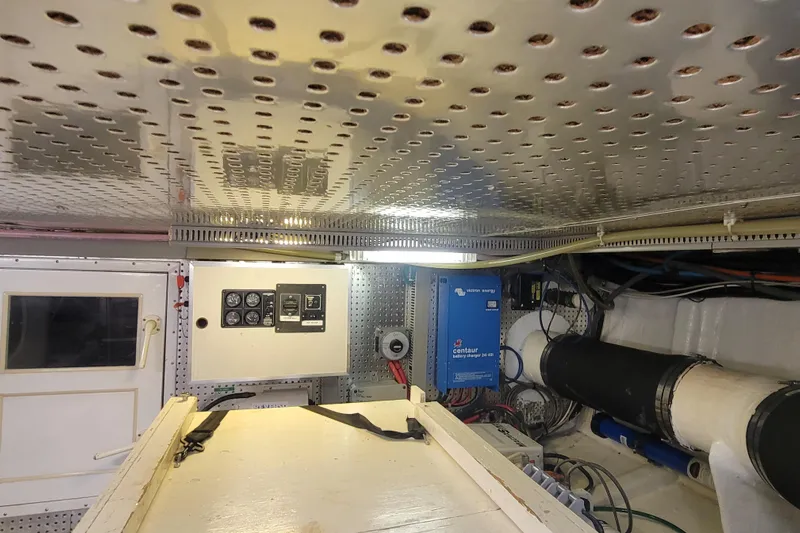 Fellowship Yacht Photos Pics Engine room of 2001 Grand Alaskan Pilothouse with control panels and equipment.