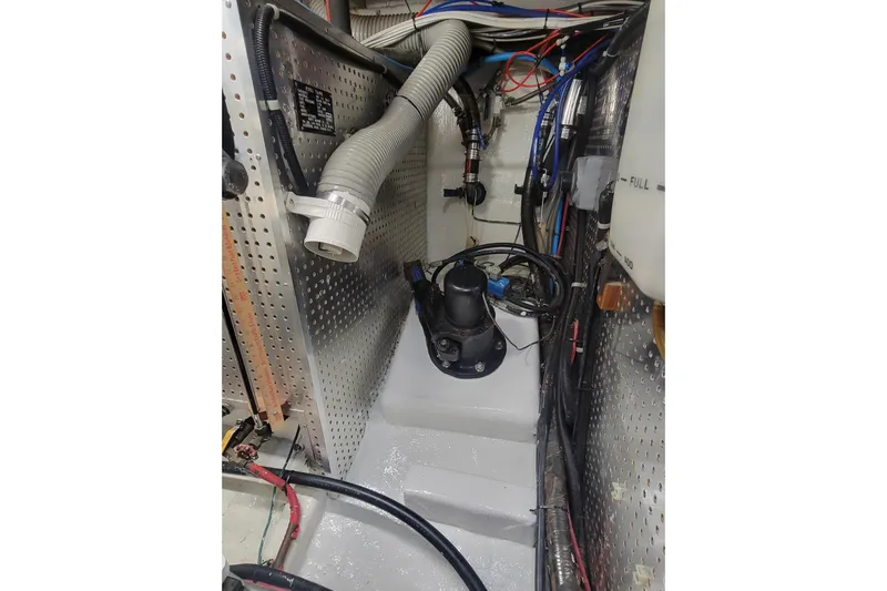 Fellowship Yacht Photos Pics Engine room of 2001 Grand Alaskan Pilothouse with hoses and wiring.