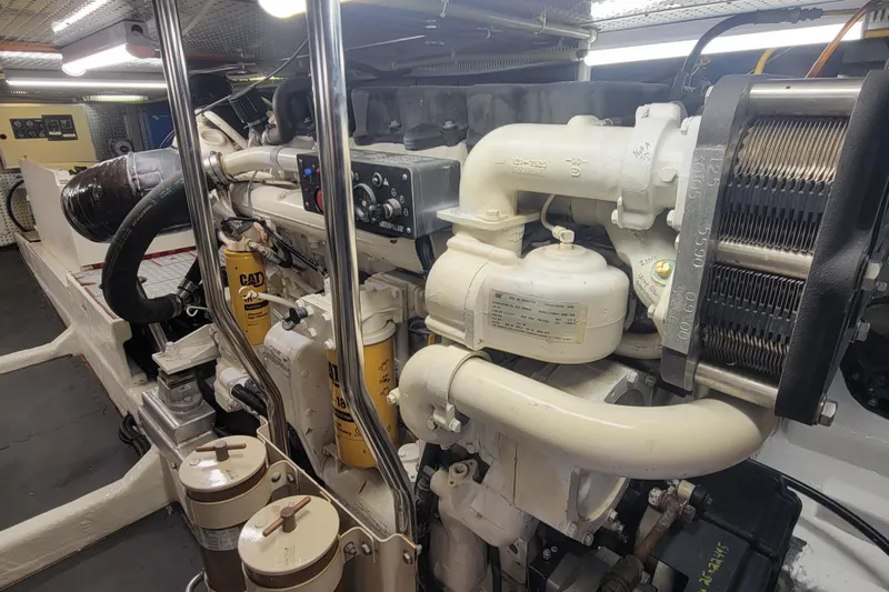 Fellowship Yacht Photos Pics Engine room of a 2001 Grand Alaskan Pilothouse yacht, showcasing detailed machinery components.