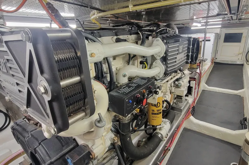 Fellowship Yacht Photos Pics Engine room of 2001 Grand Alaskan Pilothouse yacht, featuring CAT marine engine.