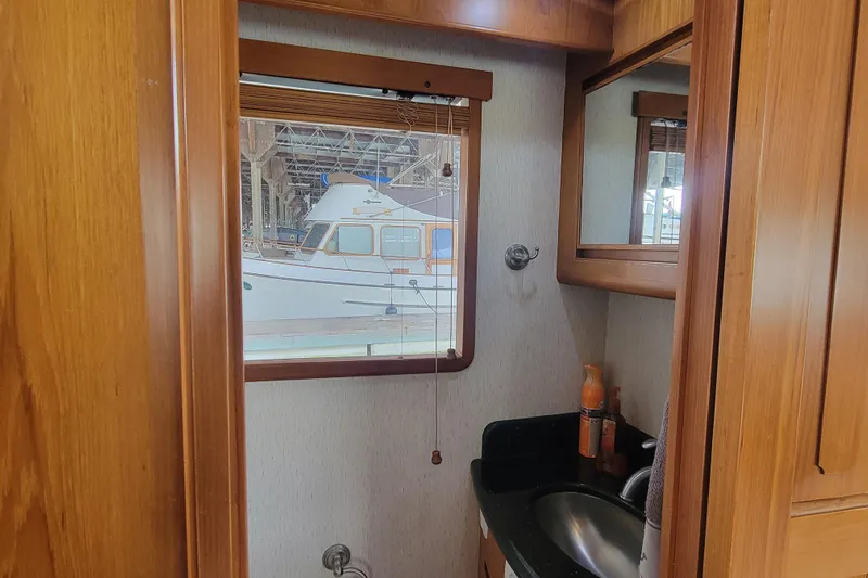 Fellowship Yacht Photos Pics 2001 Grand Alaskan Pilothouse interior with window view of docked boat.