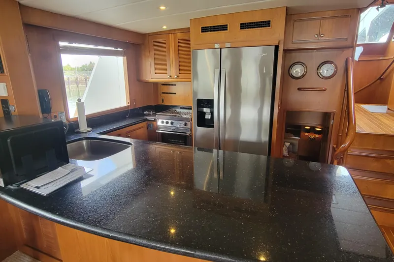 Fellowship Yacht Photos Pics Luxurious 2001 Grand Alaskan Pilothouse kitchen with modern appliances and sleek countertops.