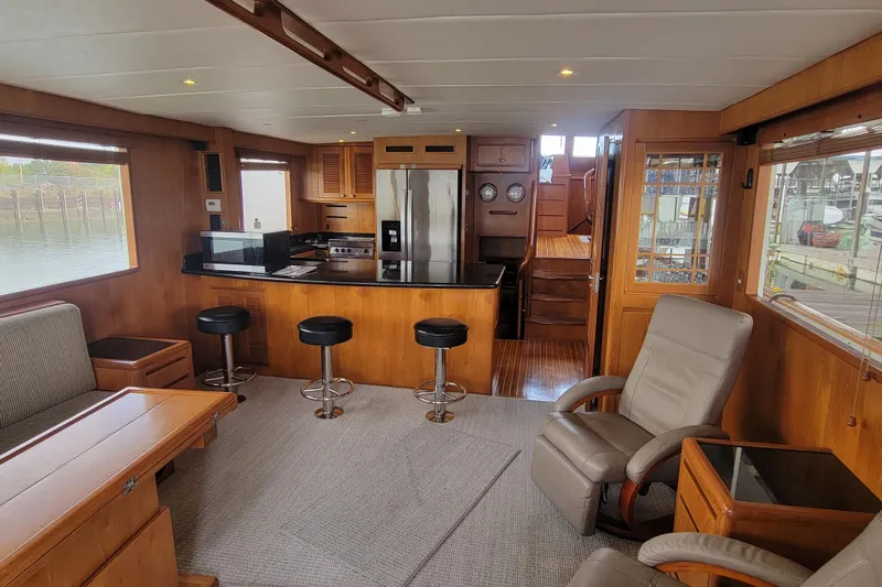 Fellowship Yacht Photos Pics Luxurious 2001 Grand Alaskan Pilothouse interior with modern kitchen and comfortable seating.