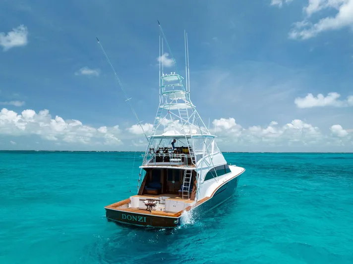 Diggin Donzi Yacht Photos Pics 2007 Donzi 73 Sportfish yacht on clear turquoise water, showcasing sleek design and fishing tower.